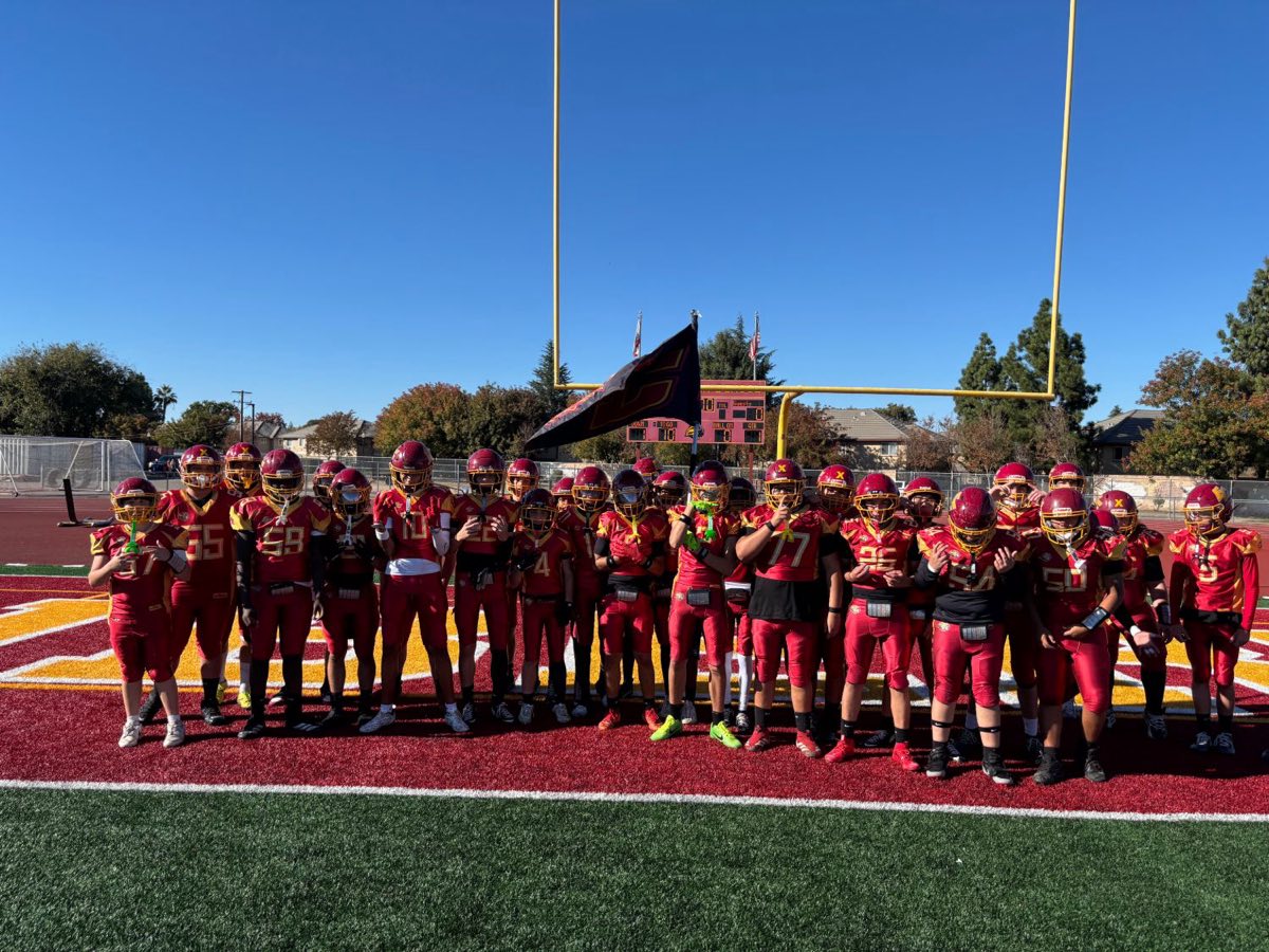 East County Lions football team in red uniforms lined up on the field before a game
